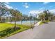 Community tennis courts with green fencing, shade trees, and well-maintained landscaping at 903 Gondola Park Dr # 903, Venice, FL 34292