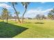 Expansive view of lush green lawn, mature shade trees, and community in the distance at 903 Gondola Park Dr # 903, Venice, FL 34292
