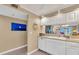 Kitchen area with a sink, dishwasher, and plenty of cabinet storage space for a functional cooking experience at 936 Capri Isles Blvd # 104, Venice, FL 34292