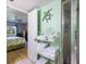 Bathroom with a view into the bedroom; features decorative turtle and shower at 944 Capri Isles Blvd # 103, Venice, FL 34292