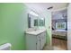 Well-lit bathroom with a view into the bedroom, featuring a white vanity at 944 Capri Isles Blvd # 103, Venice, FL 34292