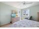 Bright bedroom with a ceiling fan and a television on top of a dresser at 944 Capri Isles Blvd # 103, Venice, FL 34292