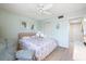 Well-lit bedroom with seating area, ceiling fan, and light green walls at 944 Capri Isles Blvd # 103, Venice, FL 34292