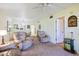 Comfortable living area featuring neutral tones, a view of the dining area, and golf-themed decor at 944 Capri Isles Blvd # 103, Venice, FL 34292