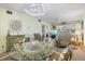 Inviting living room with comfortable seating, glass table and sliding doors to outdoor at 944 Capri Isles Blvd # 103, Venice, FL 34292
