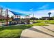 Legacy Park features a colorful train-themed playground, picnic tables and park benches amid lush green grass at 944 Capri Isles Blvd # 103, Venice, FL 34292