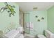 Bathroom shower with glass doors, a turtle decoration, and a tiled interior at 944 Capri Isles Blvd # 103, Venice, FL 34292