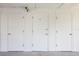 Multiple storage units with white doors, offering practical solutions for organizing and storing belongings at 944 Capri Isles Blvd # 103, Venice, FL 34292