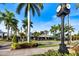Charming street view of downtown Venice features palm trees, a clock, shops and restaurants with awnings at 944 Capri Isles Blvd # 103, Venice, FL 34292