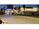 Exterior shot of the community clubhouse featuring a well-lit entrance and manicured landscaping at 9808 Bright Water Dr, Englewood, FL 34223