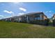 Beautiful backyard featuring a well-manicured lawn, screened-in lanai and manicured shrubbery at 9900 Haze Dr, Venice, FL 34292