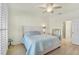 Relaxing bedroom with a plush bed and stylish ceiling fan at 9900 Haze Dr, Venice, FL 34292
