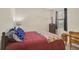 Cozy bedroom features comfortable bed, vintage cabinet, and ample natural light from the window at 9900 Haze Dr, Venice, FL 34292