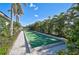 Well-maintained bocce ball court surrounded by lush landscaping and greenery in a tropical community at 9900 Haze Dr, Venice, FL 34292