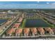 Picturesque aerial view of a community featuring houses surrounding a series of ponds at 9900 Haze Dr, Venice, FL 34292