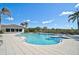 Resort-style community pool with sparkling blue water, ample seating, and tropical landscaping at 9900 Haze Dr, Venice, FL 34292