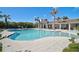 Beautiful community pool featuring poolside seating and tropical palms for a relaxing experience at 9900 Haze Dr, Venice, FL 34292