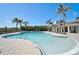 Relaxing community pool with sun loungers and umbrellas, offering a perfect space for outdoor recreation at 9900 Haze Dr, Venice, FL 34292