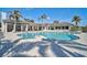 Stunning community pool featuring ample lounge seating and umbrellas perfect for relaxation and socialization at 9900 Haze Dr, Venice, FL 34292