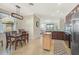 Open-concept dining area next to a kitchen featuring modern appliances, a dining table, and an island at 9900 Haze Dr, Venice, FL 34292