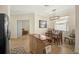 Bright dining area adjacent to the kitchen featuring wood table and chairs plus modern lighting at 9900 Haze Dr, Venice, FL 34292