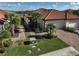 Charming single-story home boasts a tile roof, well-manicured lawn, and mature palm trees at 9900 Haze Dr, Venice, FL 34292
