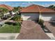 Aerial view of a home with a tile roof, two-car garage, and well-maintained landscaping at 9900 Haze Dr, Venice, FL 34292