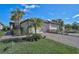 Charming single-Gathering home with a two-car garage and well-maintained front lawn and tropical landscaping at 9900 Haze Dr, Venice, FL 34292