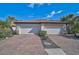 Charming home featuring a tile roof, well-manicured landscaping, and a spacious brick driveway at 9900 Haze Dr, Venice, FL 34292