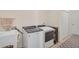 Well-equipped laundry room with modern washer, dryer, utility sink, and convenient closet space at 9900 Haze Dr, Venice, FL 34292