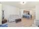Spacious living room showcasing a comfortable sofa and open view to the modern kitchen with breakfast bar at 9900 Haze Dr, Venice, FL 34292