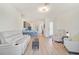 Bright and airy living room featuring wood floors and an open floor plan leading to the kitchen at 9900 Haze Dr, Venice, FL 34292