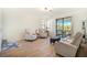 Cozy living room with a sliding glass door offering access to the balcony and natural light at 9900 Haze Dr, Venice, FL 34292