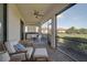 Enjoy the outdoors on this screened-in patio, complete with cozy seating and a peaceful backyard view at 9900 Haze Dr, Venice, FL 34292