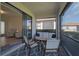 Relaxing outdoor patio with comfortable seating, sliding glass doors, and a serene view at 9900 Haze Dr, Venice, FL 34292