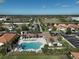 Aerial view of a large, inviting community pool with ample lounge seating and manicured landscaping at 9900 Haze Dr, Venice, FL 34292
