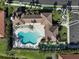 Aerial view of a community pool with a unique shape and a building with a brown roof at 9900 Haze Dr, Venice, FL 34292