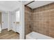 Bathroom with tiled shower and tub, white cabinets, and neutral colors at 1 Colony Point Dr # 11A, Punta Gorda, FL 33950