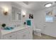 Bright bathroom featuring a marble vanity, white cabinets, a wall mirror, and natural lighting at 1 Colony Point Dr # 11A, Punta Gorda, FL 33950