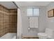 Bathroom with tiled shower and tub, white toilet, and neutral colors at 1 Colony Point Dr # 11A, Punta Gorda, FL 33950