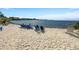 Picturesque beach featuring soft sand, lounge chairs, and people enjoying the serene waterfront view under a sunny sky at 1 Colony Point Dr # 11A, Punta Gorda, FL 33950