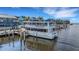 Picturesque waterfront featuring a boat docked at a charming pier with nearby buildings, offering stunning views at 1 Colony Point Dr # 11A, Punta Gorda, FL 33950