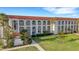 Multi-story condo building with manicured lawns and beautiful landscaping at 1 Colony Point Dr # 11A, Punta Gorda, FL 33950