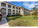 A multi-story residential building featuring multiple balconies and lush landscaping at 1 Colony Point Dr # 11A, Punta Gorda, FL 33950