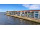 Elegant waterfront condos with red tile roofs and stunning water views from multiple windows at 1 Colony Point Dr # 11A, Punta Gorda, FL 33950