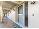 Charming covered front entryway with tiled flooring and a secure screen door at 1 Colony Point Dr # 11A, Punta Gorda, FL 33950