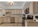 Modern kitchen featuring stainless steel appliances, tile backsplash, granite countertops, and updated fixtures at 1 Colony Point Dr # 11A, Punta Gorda, FL 33950