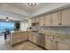 Modern kitchen with stainless steel appliances, granite countertops, lots of storage, and water view through to dining area at 1 Colony Point Dr # 11A, Punta Gorda, FL 33950