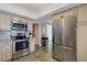 Beautiful kitchen featuring stainless steel appliances and modern cabinets, conveniently located near the refrigerator at 1 Colony Point Dr # 11A, Punta Gorda, FL 33950
