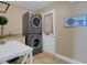 Well-equipped laundry room with stacked washer and dryer units and a utility sink at 1 Colony Point Dr # 11A, Punta Gorda, FL 33950